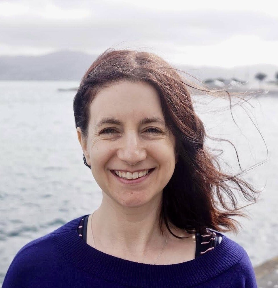 Photo of Shona Riddell by the sea on a windy day.